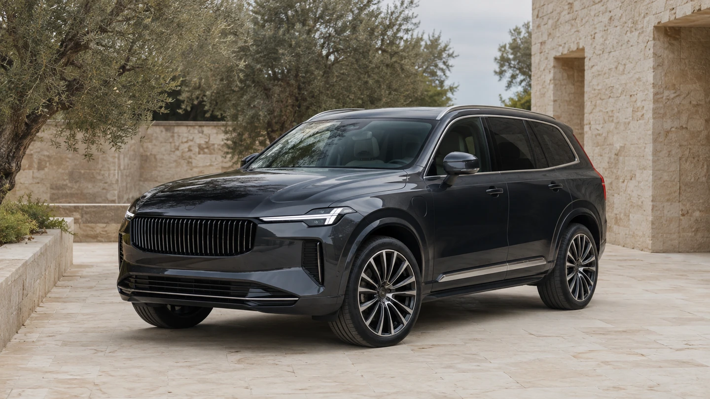 Deep charcoal premium SUV parked beside warm limestone architecture.