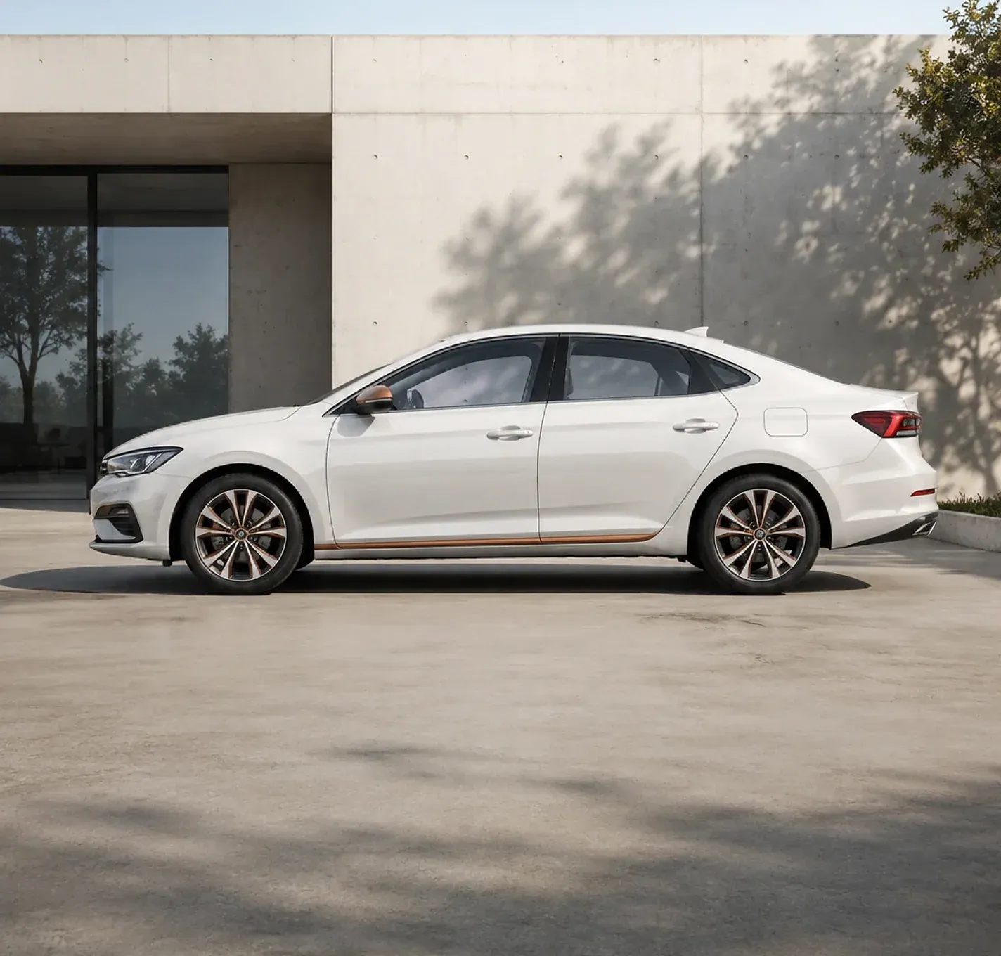 White compact sedan beside a modern concrete wall.